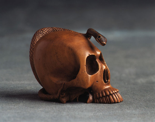 A finely carved Japanese boxwood Okimono of a skull